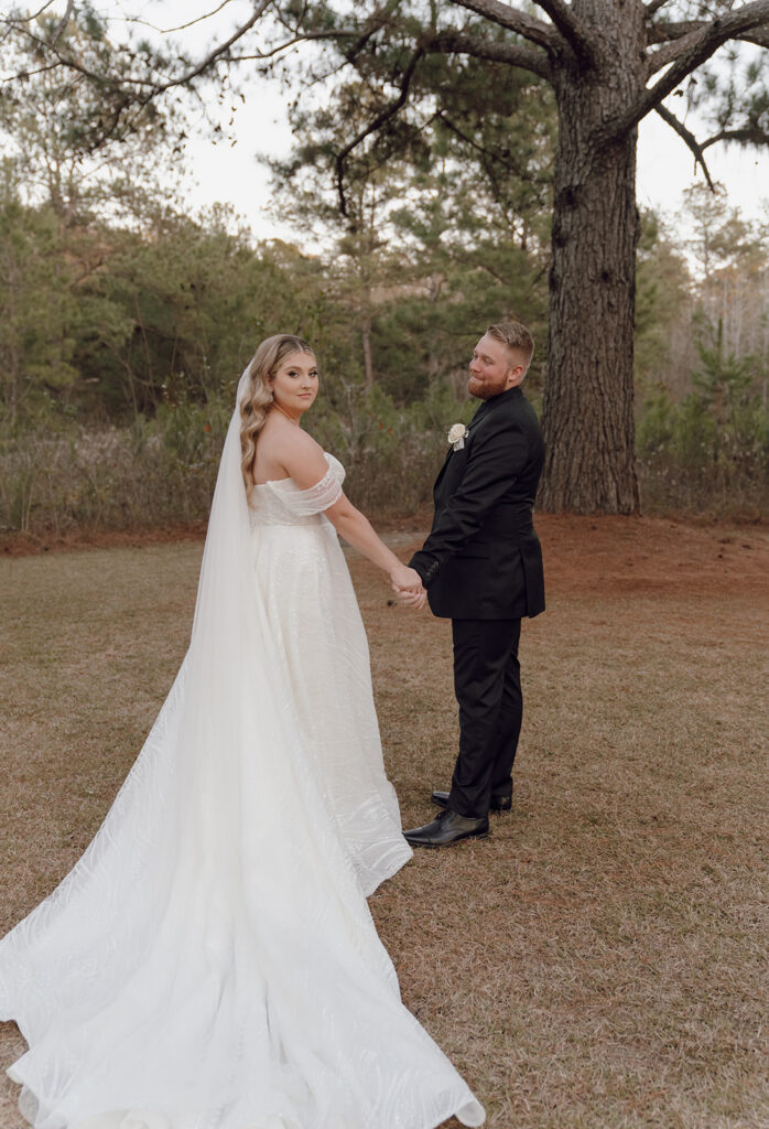 Groom admiring his bride at their Tallahassee wedding venue, Loblolly Rise.