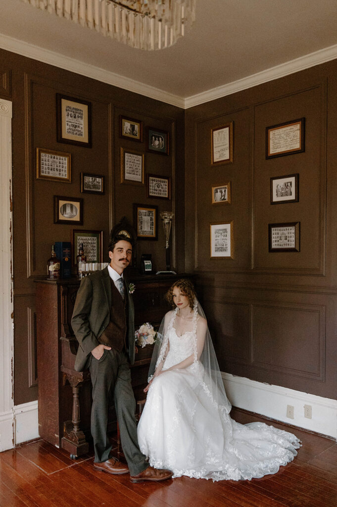 Bride and groom by a piano at The Avera-Clarke House, a favorite of Tallahassee wedding venues.