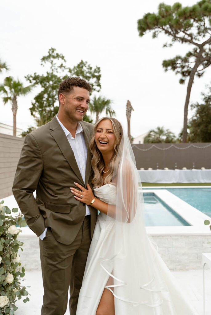 Bride and groom laughing.