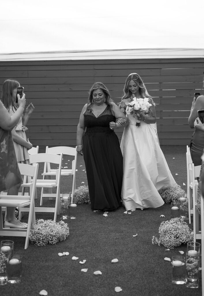 Bride walking down the aisle with her mother.
