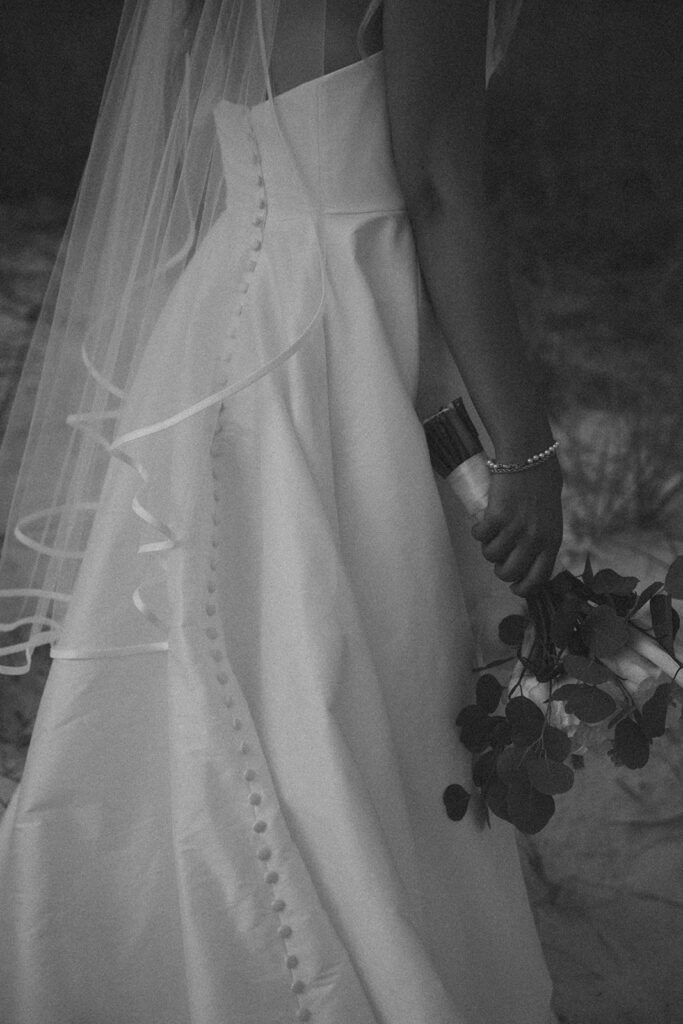 Bride in her wedding dress on the beach.